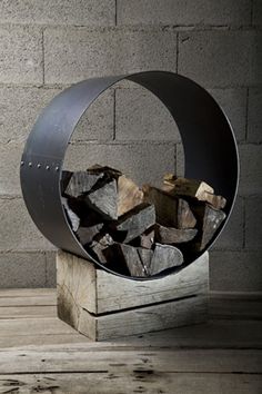 a metal sculpture with logs inside of it