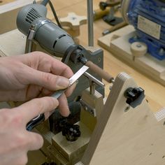 a person using a power tool on a piece of wood