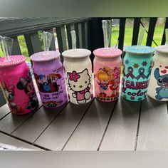 the hello kitty tumblers are lined up on the deck