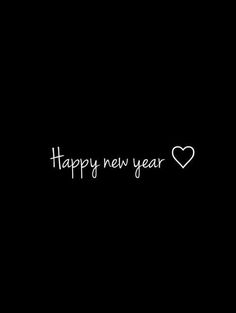 the words happy new year written in white ink on a black background with a heart