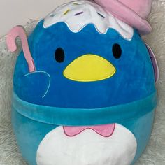 a blue stuffed animal with a pink hat on it's head