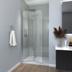 a bathroom with a glass shower door and wood flooring on the walls, along with a towel rack