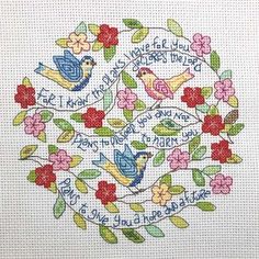 a cross stitch pattern with two birds and flowers on the bottom, saying i love you so much