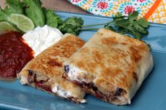 a blue plate topped with two quesadillas and salsa