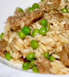 a white plate topped with rice and peas