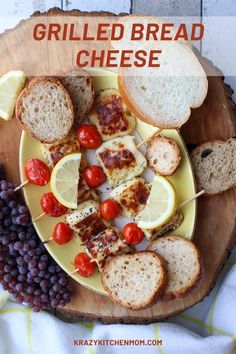 grilled bread and cheese on a yellow plate with grapes, lemons and tomatoes