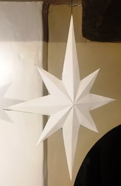 a white origami star sitting on top of a table