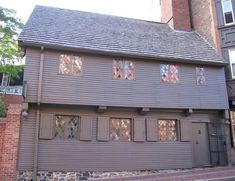 a large gray house with windows on the side