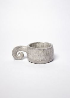 a silver ring with a spiral design on the outside and inside, against a white background