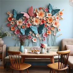 a dining room table with two chairs and a wall sculpture made out of paper flowers