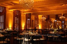 an elegant ballroom with chandeliers and tables