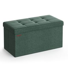 an upholstered storage box in green fabric