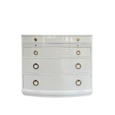 a white chest of drawers with gold handles and knobs on each drawer, against a white background