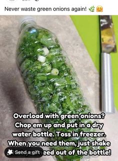 a bottle filled with green onions sitting on top of a counter