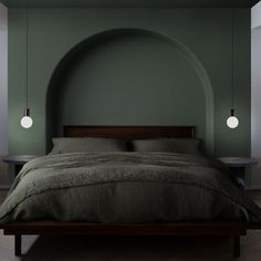 a bed with green walls and two lamps on either side of the headboard, in a bedroom