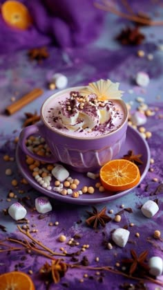 a purple cup filled with whipped cream next to an orange slice and star anise