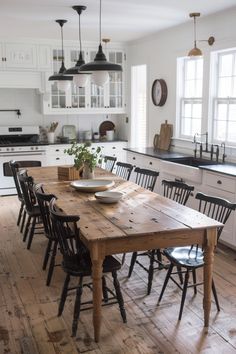 a wooden table sitting in the middle of a kitchen