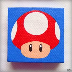 a close up of a mushroom painted on a piece of wood in blue and red