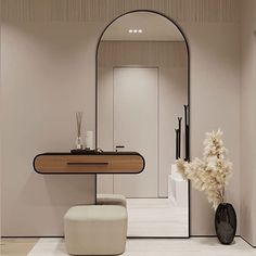 a bathroom with a mirror, stool and vase on the floor in front of it