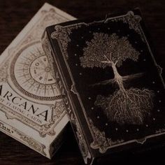 two playing cards with an image of a tree on one side and the word am written in