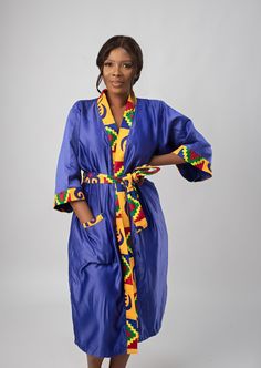 "Introducing our stunning Blue & African Kente Print Satin Kimono Robe, the epitome of comfort and elegance.  Crafted from a silky, soft satin material, it exudes an unmatched sense of opulence, making it the perfect addition to your loungewear collection. The first thing you'll notice is the vibrant and mesmerising African Kente print that adorns this robe. It features a captivating array of colours and patterns that pay homage to the rich traditions and heritage of Africa. The silky-smooth fabric caresses your skin, creating a sensation of pure indulgence. Its lightweight and breathable nature make it ideal for any season, ensuring you stay comfortable year-round. This robe isn't just for your personal enjoyment; it's also a thoughtful and timeless gift for a special person in your life. Kente Print, Satin Kimono, Timeless Gifts, Womens Robes, Comfort Color, Kimono Sleeve, Geometric Graphic, Satin Material, Waxed Cotton