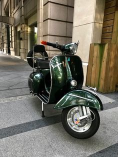 a green scooter is parked on the street