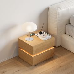 a small table with a light on it next to a couch