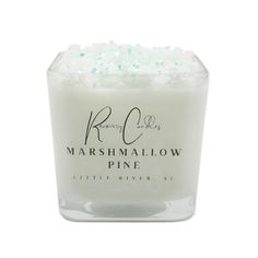 marshmallow pine candle with white frosting in a clear glass container on a white background