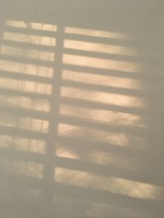 the shadow of a window on a white wall