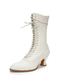 a pair of white boots with laces on the side and heeled soles