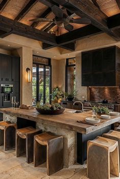 a large kitchen with an island in the middle and lots of stools around it