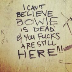 graffiti written on the side of a wall saying i can't believe bowe is dead if you flicks are still here