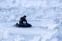 a person on a snowmobile in the middle of some deep snow and ice mounds