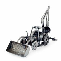 a metal model of a tractor with a snow plow attached to it's front wheel