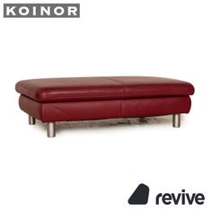 a red leather ottoman sitting on top of a metal frame bench with the konor logo above it