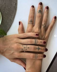 two women with matching tattoos on their hands