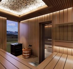 a sauna room with wood paneling and a large window overlooking the mountains in the distance