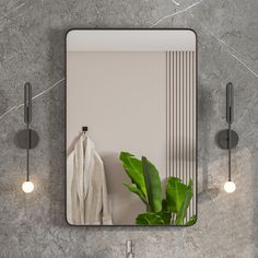 a bathroom mirror sitting on top of a wall next to a sink and two lights