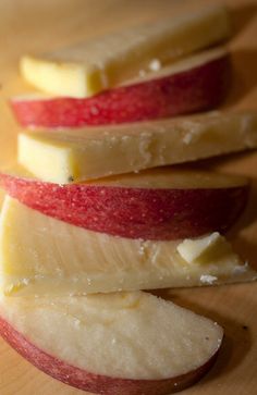 four slices of apple sitting on top of a cutting board