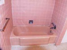 a pink tiled bathroom with a bathtub and shower