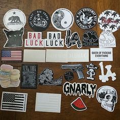 various stickers and decals on a wooden surface with the words bad luck, gnarly