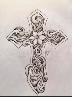 a drawing of a cross with swirls and flowers on the bottom half of it