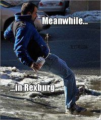 a man standing in the middle of a street with his foot up on an ice - covered sidewalk