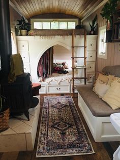 a living area with a couch, rug and fireplace in the corner next to it