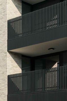 an apartment building with balconies on the second floor