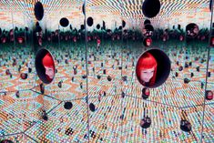 an image of a woman with red hair in the middle of a room filled with mirrors