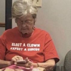 an elderly woman looking at her cell phone