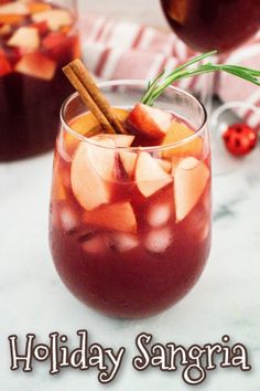 a holiday sangria with apples and cinnamon garnish