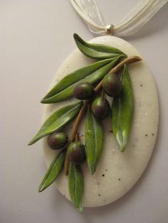 some olives are sitting on top of a round object with white string around it