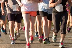 a group of people running down a road